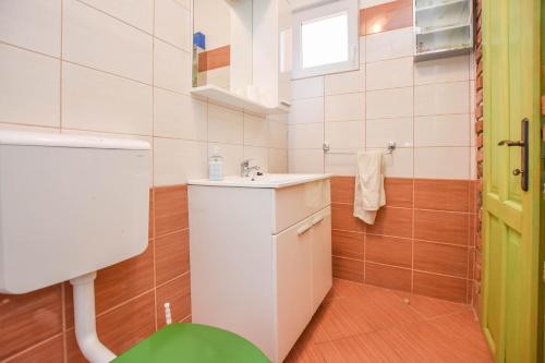 a small bathroom with a sink and a toilet at House Luce in Neviđane