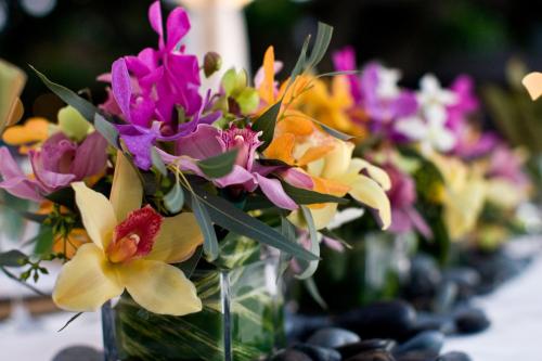 a bunch of flowers in vases on a table at Royal Lahaina Resort & Bungalows in Lahaina