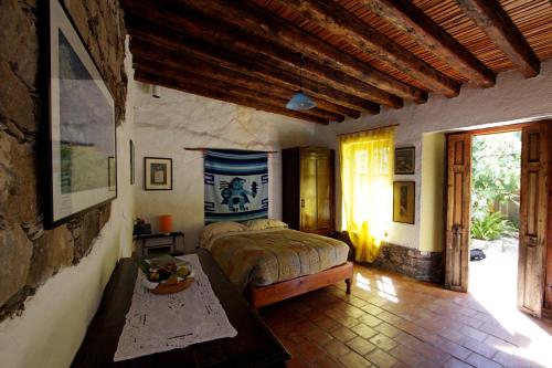 a bedroom with a bed and a table in it at Casa Curtos in Real de Catorce