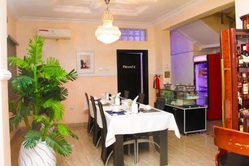 a dining room with a table and chairs in a restaurant at J Gibson Hotel in Lagos