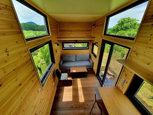 a view from the inside of a tiny house with windows at POP Tiny House Balaton in Káptalantóti