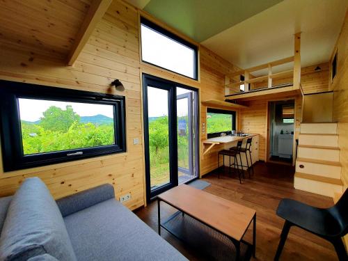 a living room with a couch and a table at POP Tiny House Balaton in Káptalantóti