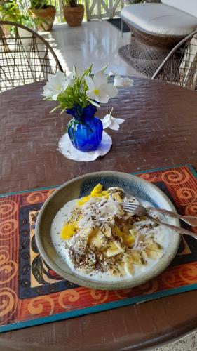 a plate of food on a table with a bowl of food at Neita's Nest in Kingston