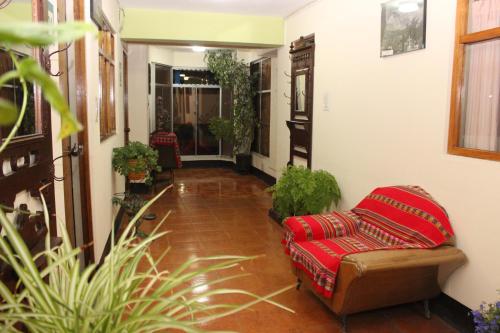 a living room with a couch and some plants at Hotel Galaxia in Huaraz