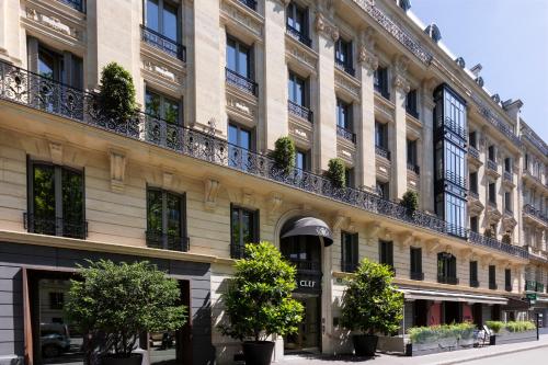 a large building with trees in front of it at La Clef Tour Eiffel Paris by The Crest Collection in Paris