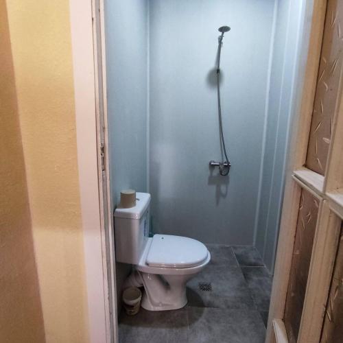 a bathroom with a white toilet in a room at Renting a full apartment in the centre of Gyumri in Gyumri