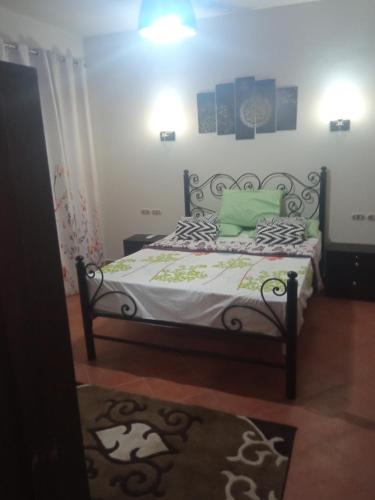 a bedroom with a bed with green pillows at شاليه فاخر بالبانوراما بورتوسخنه للعائلات فقط porto sokhna chalets in Ain Sokhna
