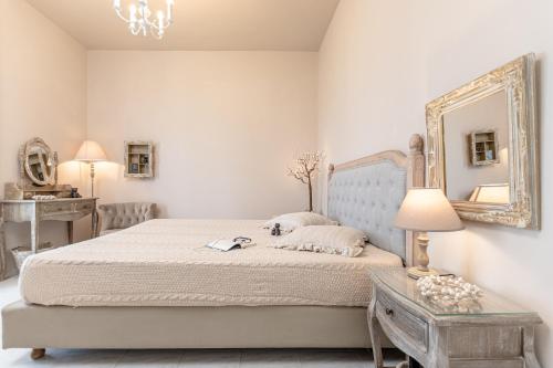 a bedroom with a bed with a mirror and a table at Black Velvet in Agkidia