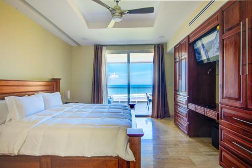 a bedroom with a bed and a view of the ocean at Break Water Point Penthouse 7th Floor in Jacó