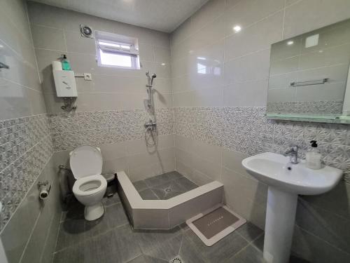a bathroom with a toilet and a sink at Home in Udabno in Udabno