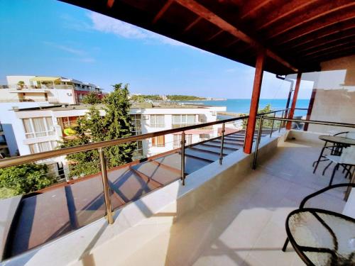 a balcony with chairs and a view of the ocean at Аурелия Бей in Ravda