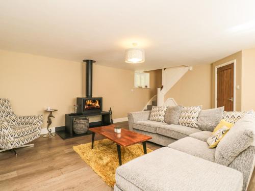a living room with a couch and a table at The Coach House in Tetbury