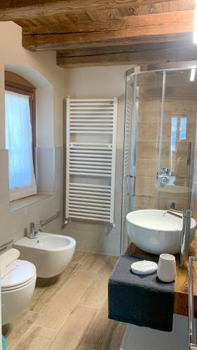 a bathroom with two sinks and a tub and a shower at Alle Macine - Historic Molino Maufet Watermill - Lake Como in Colico