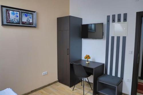 a room with a desk and a chair and a cabinet at Konak kod Hame in Bihać