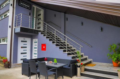 a building with a staircase and a table and chairs at Konak kod Hame in Bihać