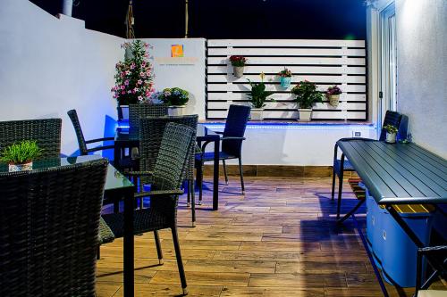 a dining room with tables and chairs and plants on a wall at La maison di Lea in Gaeta