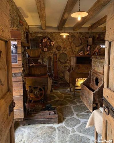 a room with an old stove in a cabin at Alle Macine - Historic Molino Maufet Watermill - Lake Como in Colico