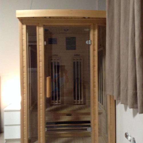a glass cabinet in a room with a curtain at ANGELO in Koper