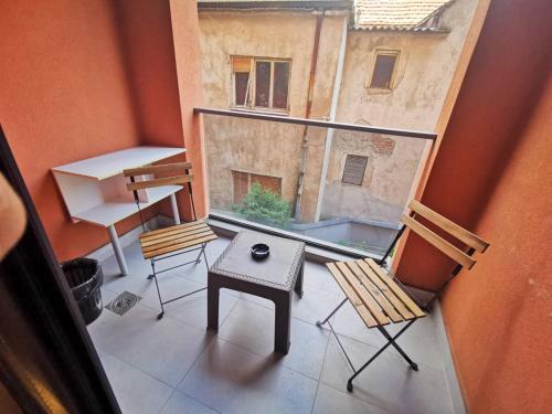 a balcony with chairs and a table and a window at Exclusive Skopje Apartments in Skopje