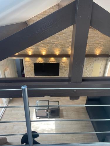 a loft bed in a room with a fireplace at Olympic Games 20 min from Paris and CDG Aeroport Luxurious House with garden and parking in Eaubonne