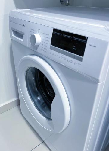 a white washing machine sitting in a room at #12Georgetown Luxury Suite with Rooftop Pool in George Town
