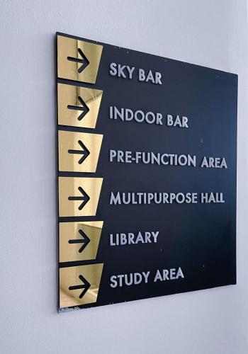 a sign with six arrows on a wall at #12Georgetown Luxury Suite with Rooftop Pool in George Town