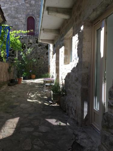 a courtyard of a house with a window and a door at Chambre d hôte La cool room in Antraigues