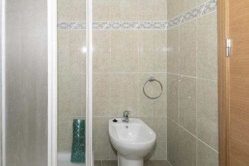 a bathroom with a white sink and a shower at Lider, 10-B in Cullera