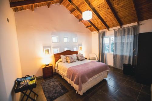 a bedroom with a bed and a large window at Bungalow Miramar & Jeronimo at Casa Marin Vineyards in Cartagena