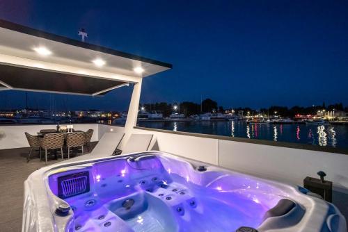 a jacuzzi tub on the deck of a boat at The Sea Lodges Novigrad - Hausboot Floating Sea House in Novigrad Istria