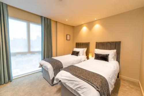 a bedroom with two beds and a window at Entire 2 Bed - Free Parking - No. 35 - The Cosy Collection Ltd in York