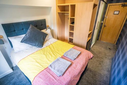 a bedroom with a bed with two towels on it at Apartment Chinatown 306 in Newcastle upon Tyne