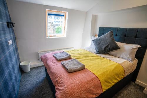 a bedroom with a bed with two towels on it at Apartment Chinatown 306 in Newcastle upon Tyne
