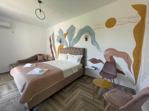 a bedroom with a bed and a painting on the wall at Belami luxury apartments in Ulcinj