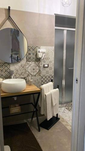 a bathroom with a sink and a mirror at B&B Antica Hera in Foce del Sele
