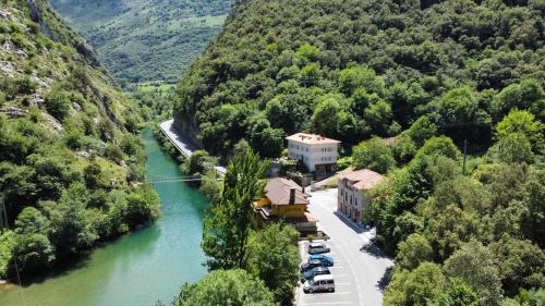 an aerial view of a building next to a river at Las Dos Peñas in Mier