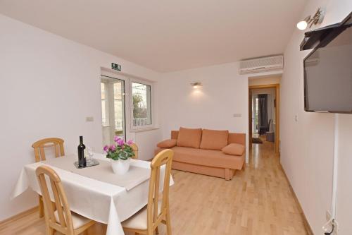 a living room with a table and a couch at Apartment Mate in Omiš