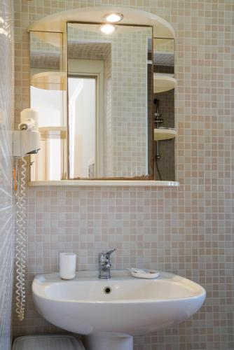 a bathroom with a sink and a mirror at B&B Sara in Santa Maria al Bagno