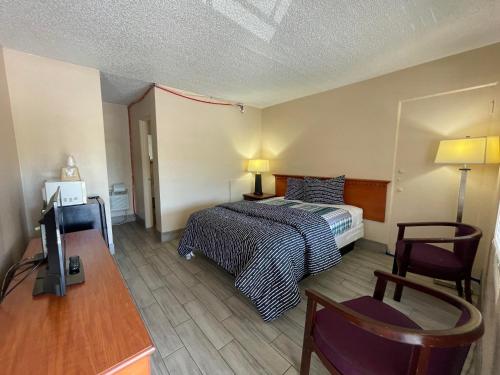 Ένα ή περισσότερα κρεβάτια σε δωμάτιο στο Castillo Inn