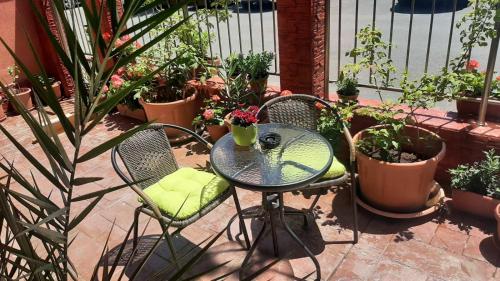 a table and chairs with plants on a patio at Adri Guest House in Nesebar