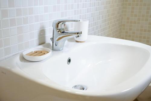 a bathroom sink with a faucet on top of it at B&B Sara in Santa Maria al Bagno