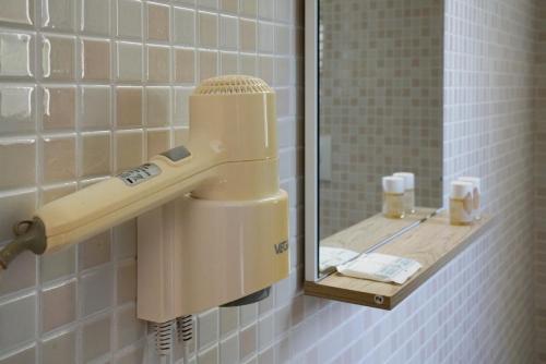 a hair dryer on a wall in a bathroom at B&B Sara in Santa Maria al Bagno