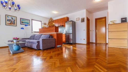 a living room with a couch and a refrigerator at Apartment Diracca in Malinska