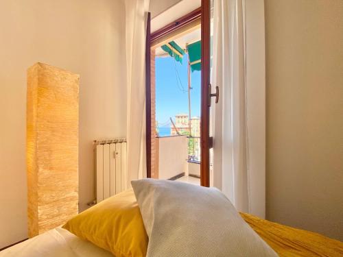 a bedroom with a window with a view of the ocean at CasaViva - Wonderful Bilo in Camogli in Camogli