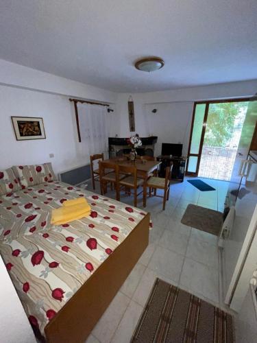 a bedroom with a bed and a dining room at The square in Mariaí