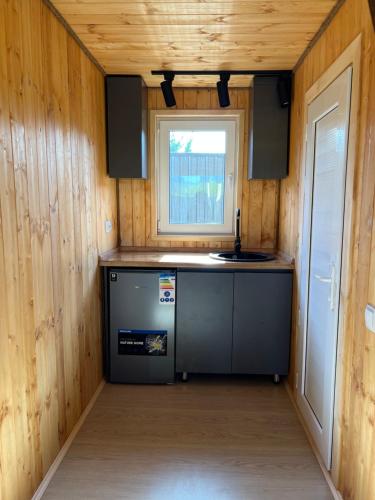 a kitchen in a tiny house with a window at Bereke Kolsay Resort in Saty