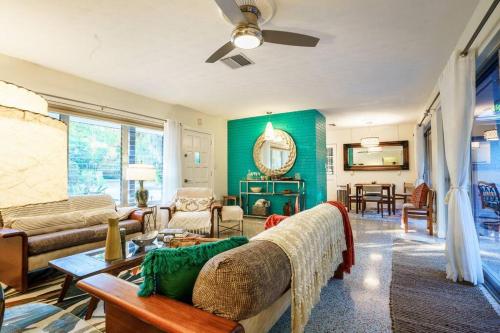 a living room with a couch and a table at Beautiful Glam Mid-Century 1 block from Sarasota bay with Firepit in Sarasota
