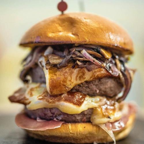 a cheeseburger with meat and cheese on a bun at APARTAMENTO MADRID Norte in San Sebastián de los Reyes