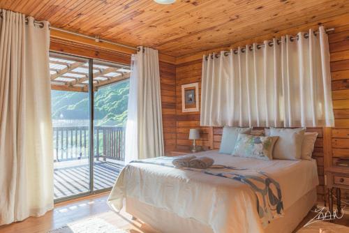 a bedroom with a bed and a large window at 29@Kamma in Eersterivierstrand