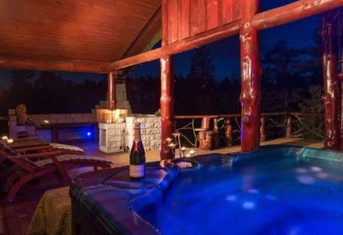 a hot tub on a deck with a bottle of wine at DaVita Ranch 